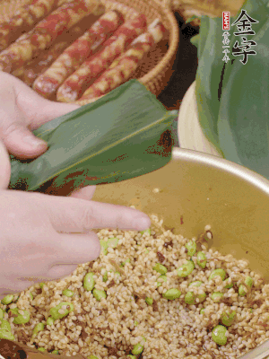 粽葉往下折，完全蓋住，兩側(cè)捏緊。